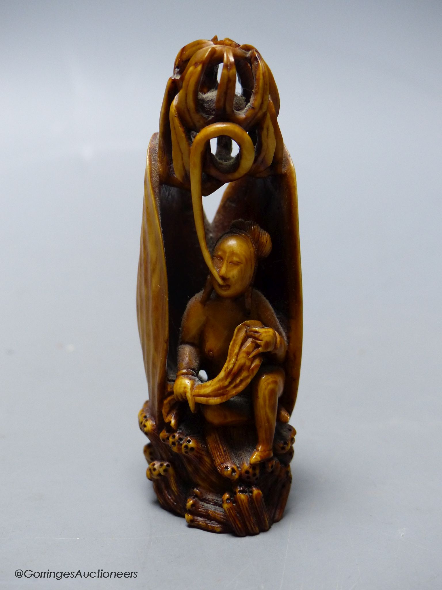 A Chinese ivory figure of a woman in a clam shell, 19th century